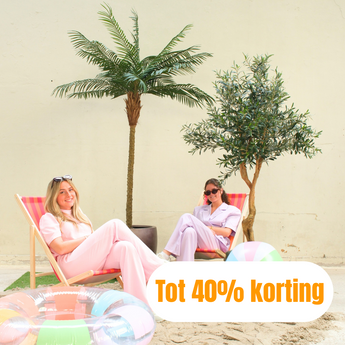 Twee vrouwen in lichtroze outfits relaxen op gestreepte ligstoelen bij bomen in potten, met opblaasbare zwembandjes op zand. De tekst luidt: Tot 40% korting in het Nederlands, wat betekent Tot 40% korting.
