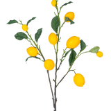 De Kunsttak Lemon 104 cm geel heeft een tak met meerdere felgele citroenen en groene bladeren tegen een witte achtergrond.