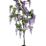 De Kunstplant Blauweregen 210 cm is een kunst blauwe regen in pot met groene bladeren en paarse bloemtrossen tegen een effen witte achtergrond.