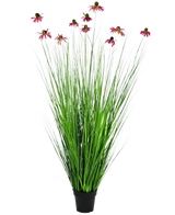 De Kunst Grasplant Chrysant 150 cm brandvertragend is een potplant met hoge, grasachtige groene bladeren en meerdere roze chrysantenbloemen met een donker hart boven het blad.