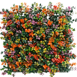 De Kunsthaag Pachysandra multi-color 50x50 cm UV is een vierkant paneel met dichte kunstgroene bladeren en kleine oranje, roze, gele en paarse bloemen voor een kleurrijk, levendig verticaal tuineffect.